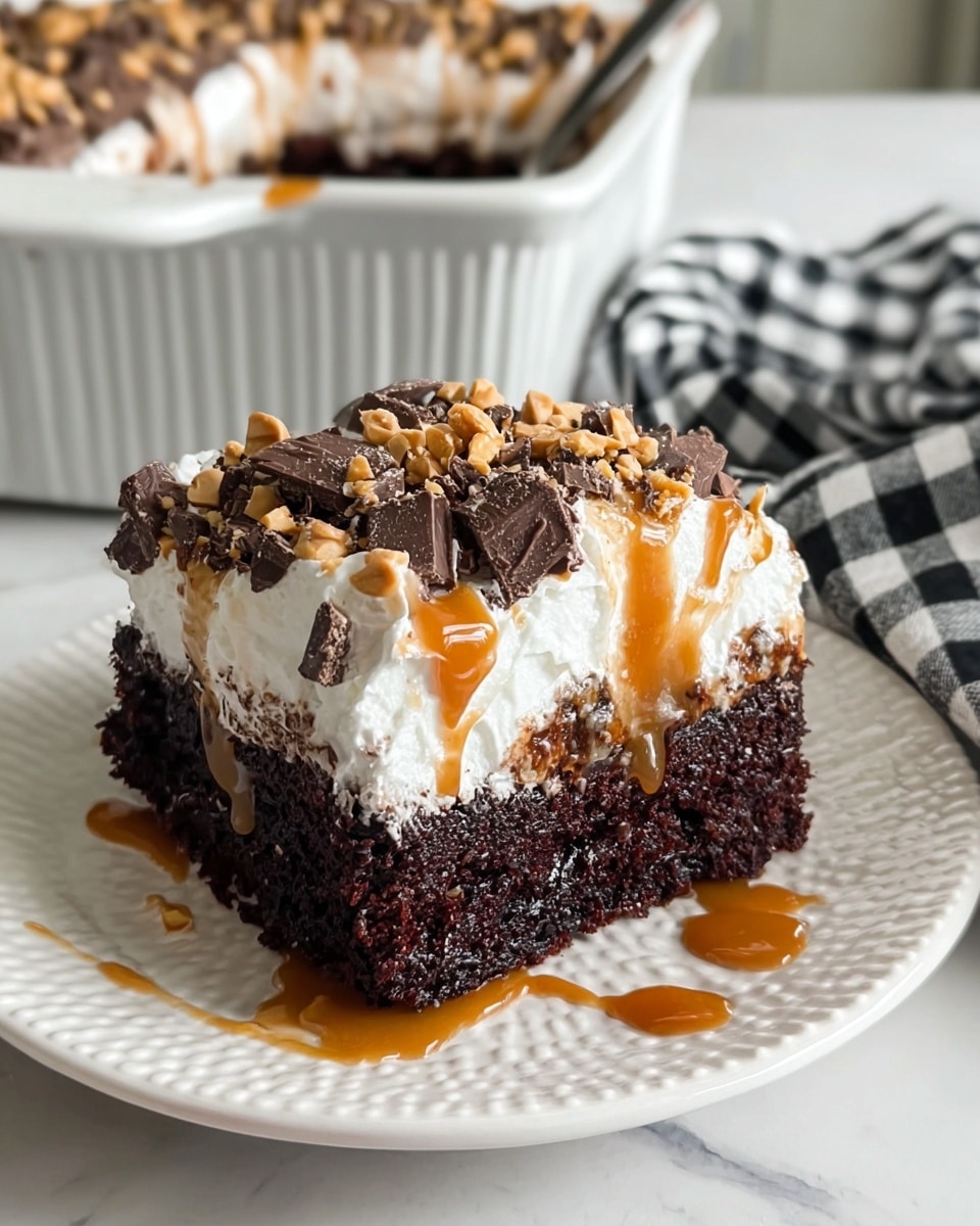 A square piece of dark, moist chocolate cake with three visible layers: a dense chocolate base soaked with caramel sauce, a thick middle layer of soft cake, and a top layer of fluffy white whipped cream. The whipped cream is generously sprinkled with chopped peanut and chocolate pieces, along with a light drizzle of caramel sauce over it. The cake sits on a white textured plate with caramel sauce drizzled decoratively around it. In the background, a white ceramic baking dish filled with the same cake is partially visible on a white marbled surface, with a black and white checkered cloth nearby. photo taken with an iphone --ar 4:5 --v 7
